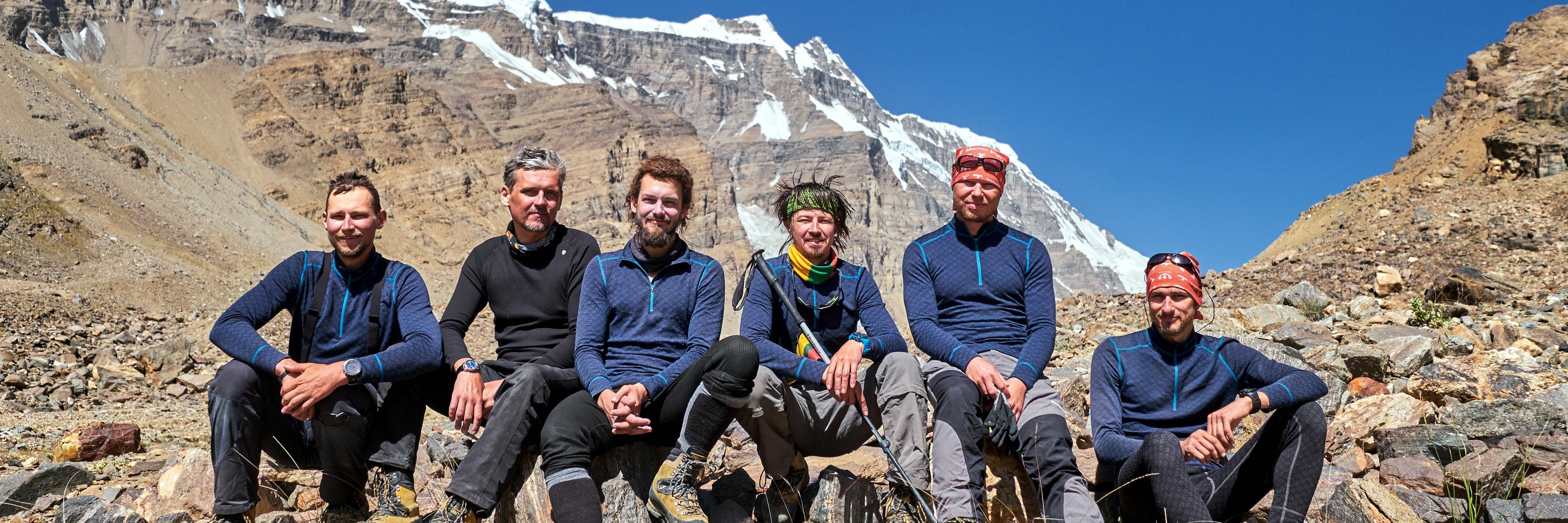 group of alpinists sitting on the rocks