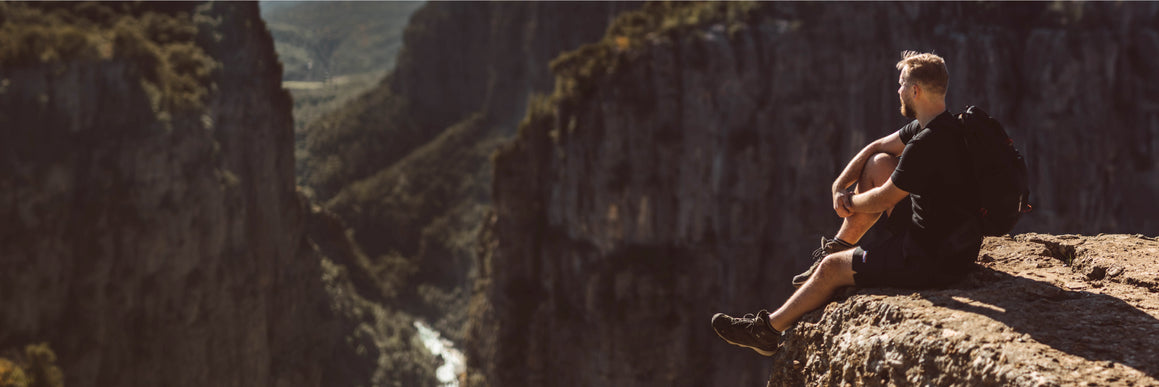a-man-climbs-a-rock-with-full-climbing-equipment