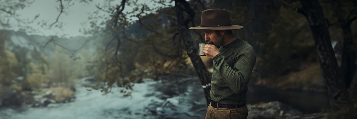 a-man-sitting-and-checking-map-in-the-forest-at-winter