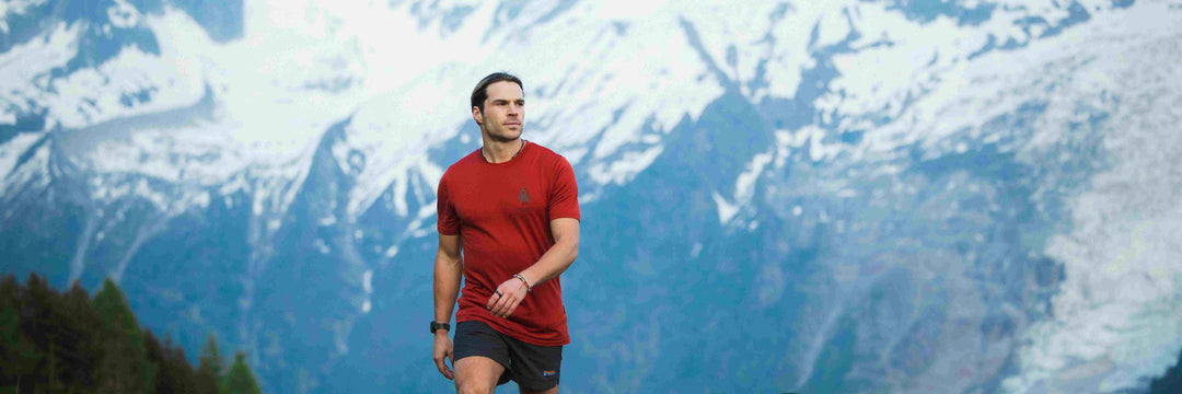 A man is wearing T-Shirt and hiking in the Mountain