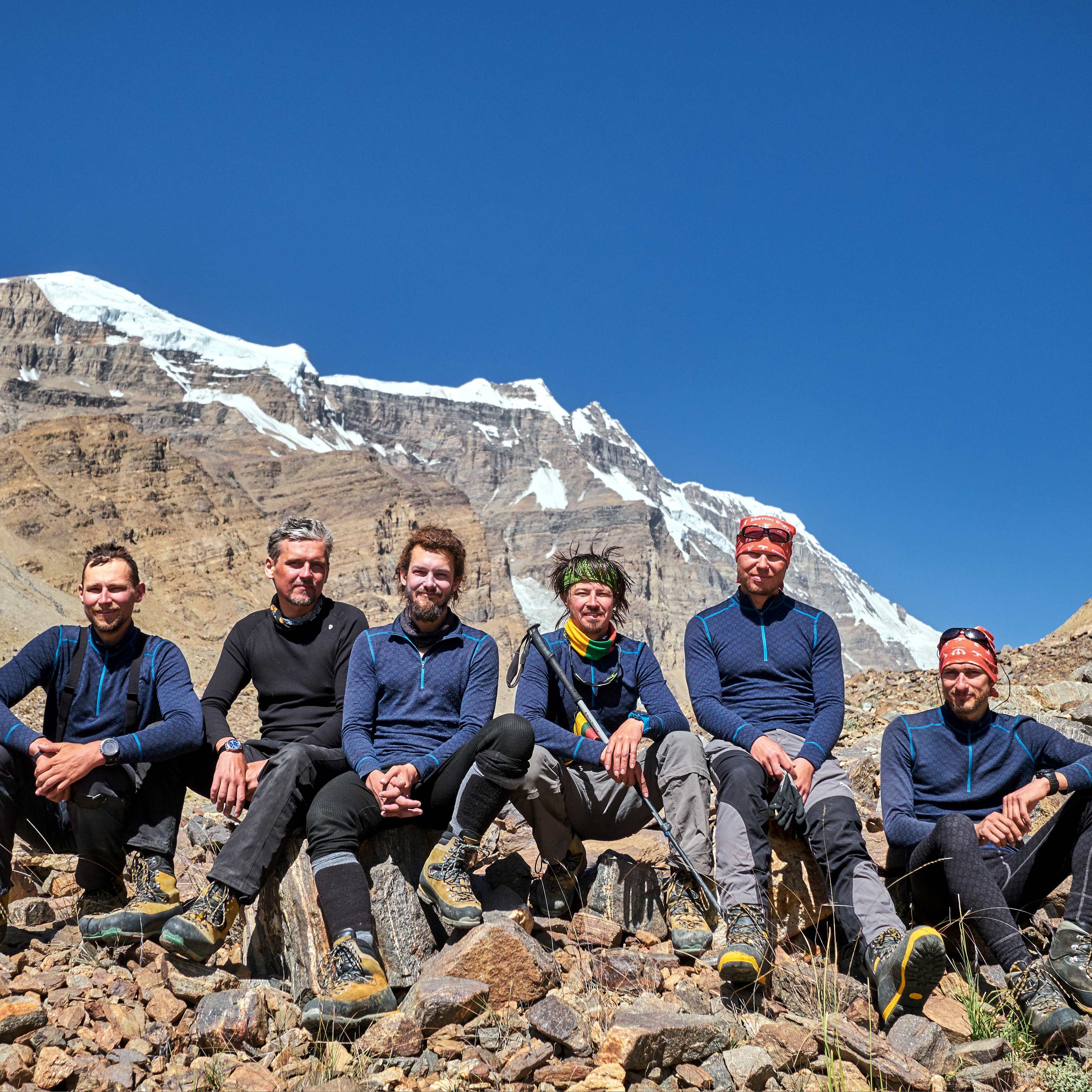 group of alpinists sitting on the rocks