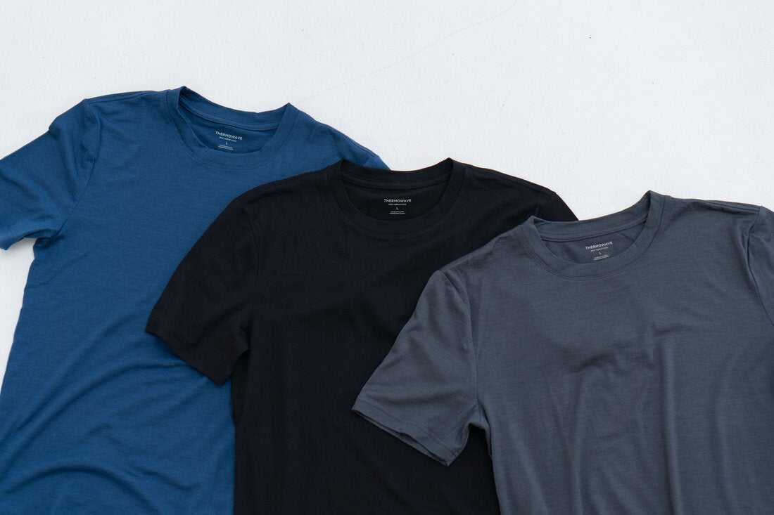 Three Merino Life T-Shirts in blue, black and anthracite, lying flat