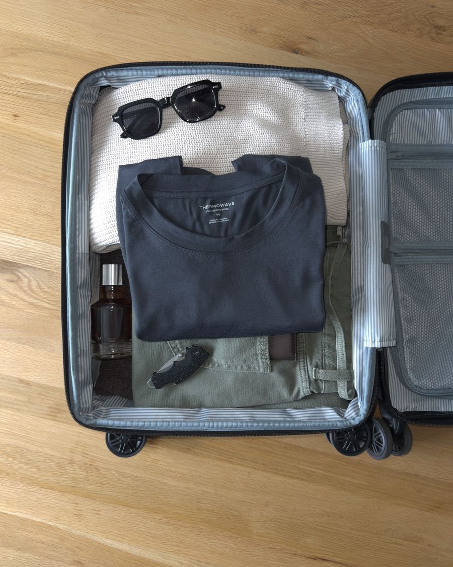 Merino Life Tee folded in an open carry-on suitcase