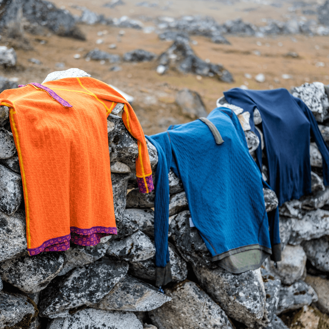 Mountaineers are drying their termo clothes on rocks in the mountains